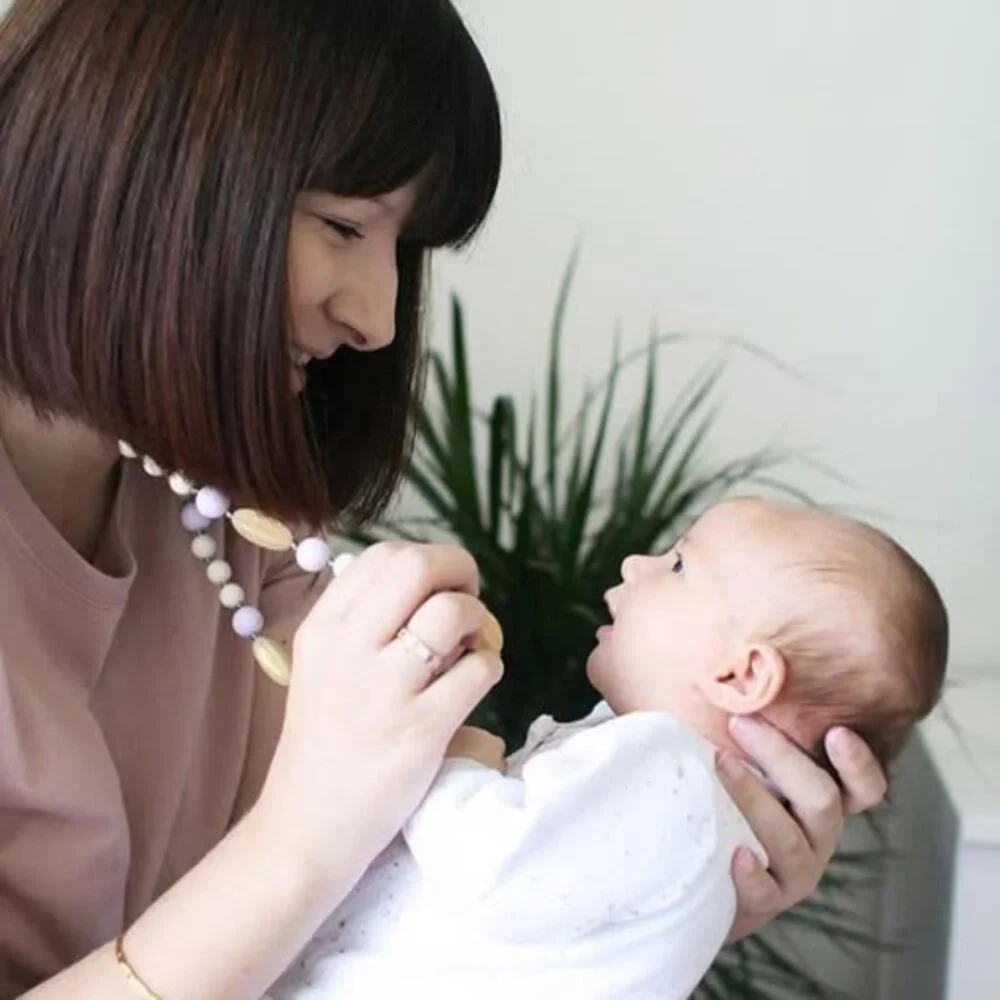 Itzy Ritzy | Teething Happens Chewable Mom Necklace | Pink & Gold